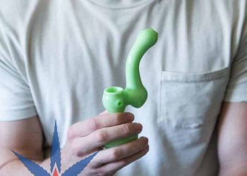 Picture of a man holdng a bubbler which is like combining a pipe and a bong.