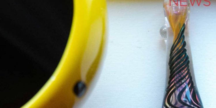One hitter next to a large smiley face coffee cup.
